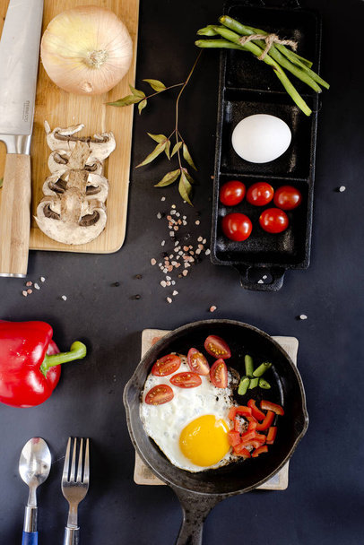 scrambled eggs with vegetables freshly prepared with additional ingredients on the table. view from above - Foto, Imagem