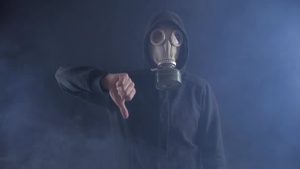 Gaz maskesi ve Hood Stalker dumanlı karanlık yer gösteren, aşağı ve söyleyerek hiçbir Thumbs. - Video, Çekim