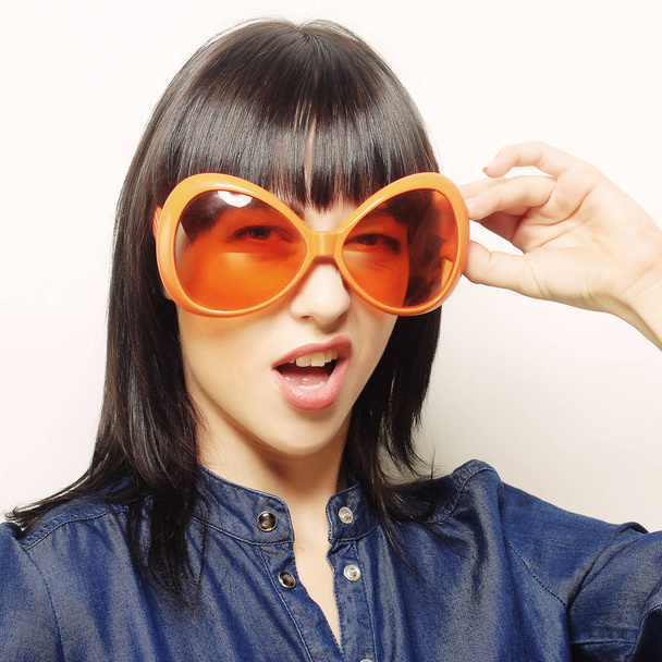 happy woman with big orange sunglasses - Foto, afbeelding