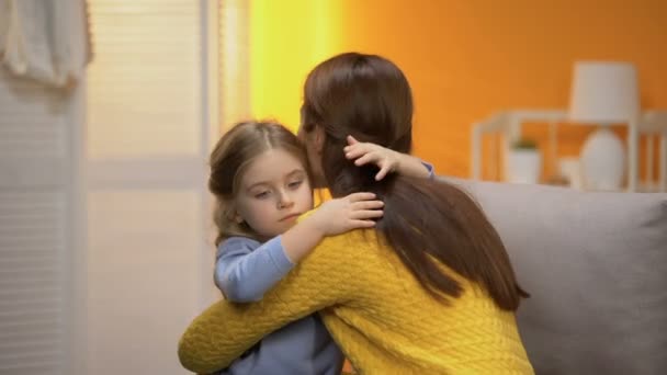 Little shy adopted girl hugging young female, beginning of new life in family - Imágenes, Vídeo