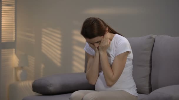 Pregnant woman suffering strong headache calling ambulance, female healthcare - Felvétel, videó