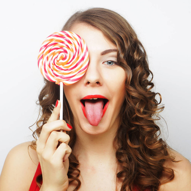 Young sexual woman holding lollipop.  - Foto, Bild