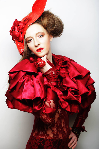 Fashion model in bright red costume and red hat - Фото, зображення