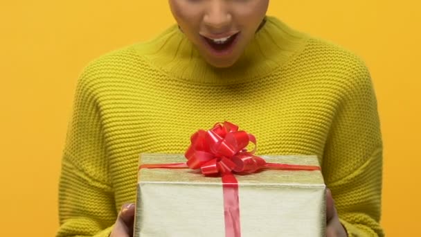 Excited pretty teenager looking gift box in hand, unexpected present, birthday - Imágenes, Vídeo