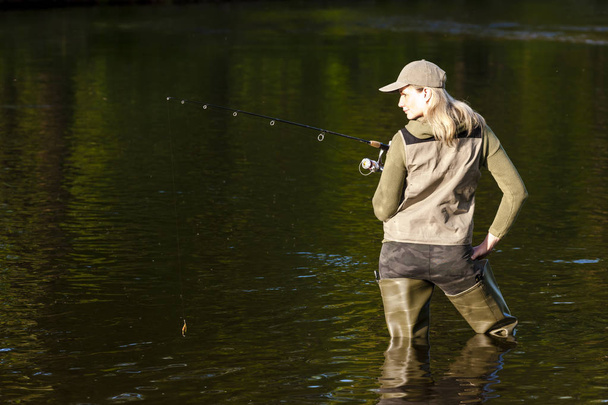 woman fishing in the river in spring - Fotó, kép