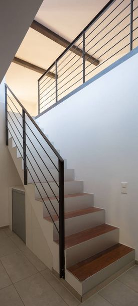 Entrance with a staircase. Nobody around. All the wall are white.  - Foto, Imagen