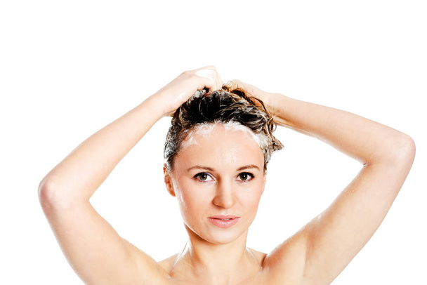Woman applying hair conditioner. - Foto, afbeelding