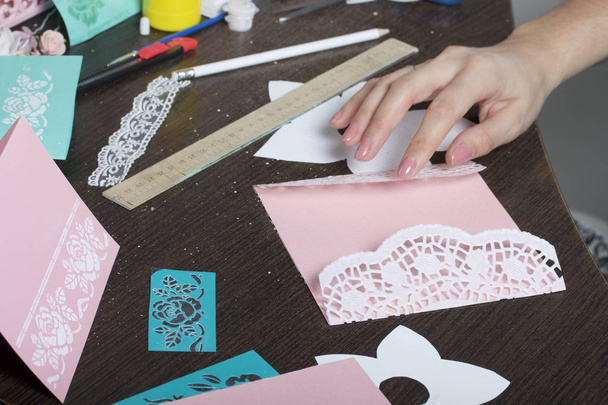 Making greeting cards from paper, cardboard and tape. Woman artisan at work. - Foto, Imagen