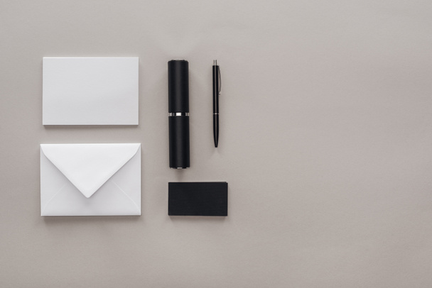 flat lay with black and white stationery on grey background - Foto, Imagen