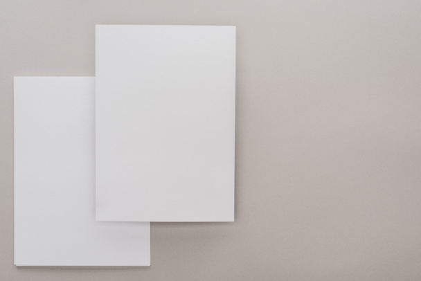 top view of white empty papers on grey background - Photo, Image