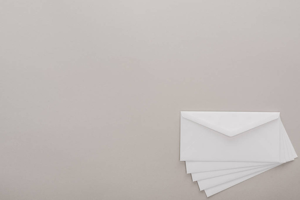 top view of white envelopes on grey background  - Zdjęcie, obraz