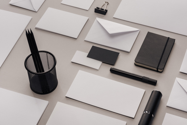 flat lay with white and black office supplies on grey background - Zdjęcie, obraz