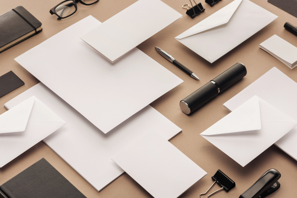Flat lay with glasses, sheets of paper, cards, pen, notebooks, stapler and paper clips - 写真・画像