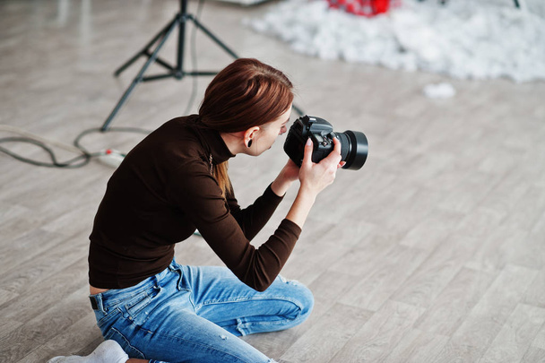 Young girl photographer shooting on studio. Professional photographer on work. - Φωτογραφία, εικόνα