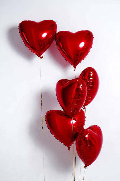 Set of Air Balloons. Bunch of red color heart shaped foil balloons isolated on white background. Love. Holiday celebration. Valentine's Day party decoration. Metallic red  Heart air balloons - Foto, imagen