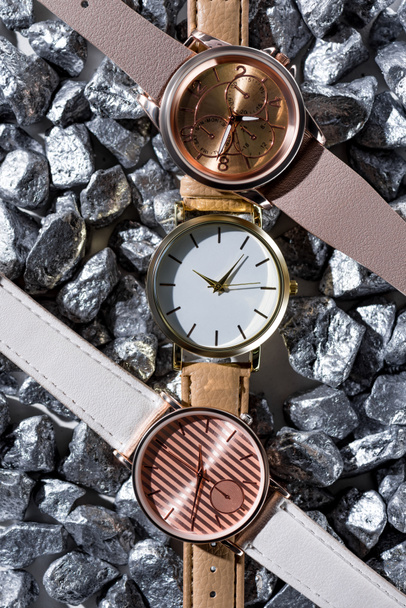 top view of wristwatches lying on grey stones  - Photo, Image