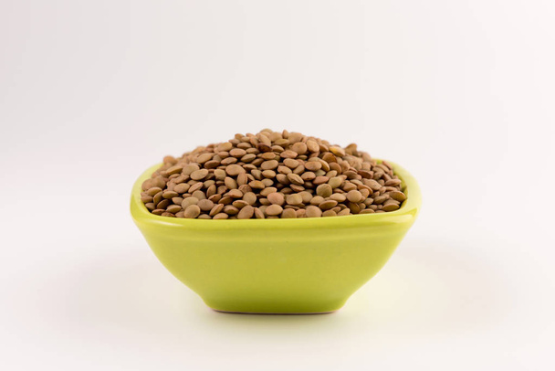 Yellow lentil in a bowl isolated on white background  - Zdjęcie, obraz