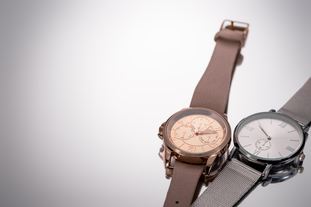 elegant swiss wristwatches lying on grey background - Fotoğraf, Görsel