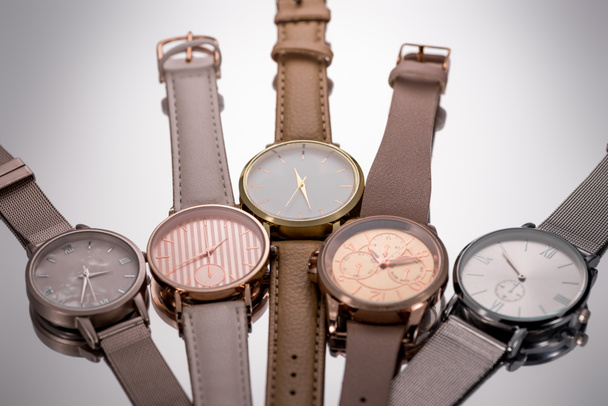 selective focus of luxury wristwatches lying on grey background - Photo, Image