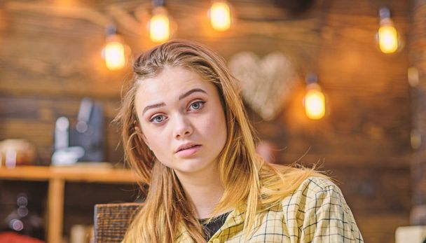 Blond girl with big green eyes, angel face and gorgeous hair posing indoors. Teenage female with amused look wearing yellow boyish shirt, youth fashion concept - Photo, Image