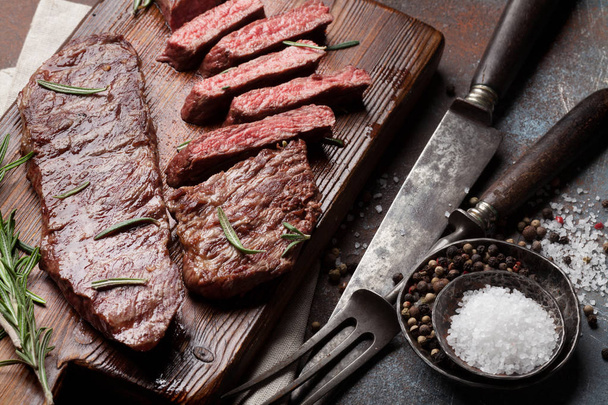 Top blade or denver grilled steak over cutting board - Photo, Image