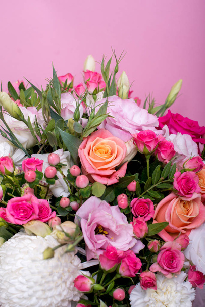beautiful floral arrangement in the box, pink and yellow rose, pink eustoma, green and pink chrysanthemum, white carnation, pink dahlia on pink background with space for text. - 写真・画像