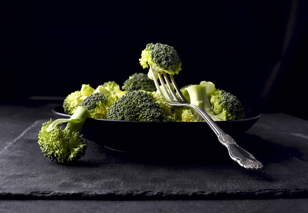 Broccoli on black  stone background - Fotó, kép