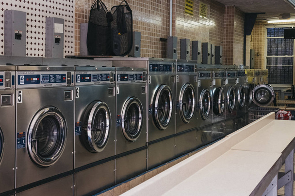 New York, USA - May 30, 2018: Interior of a laundromat in New York, the city where most locals dont have the advantage of in unit washers and dryers. - Fotó, kép