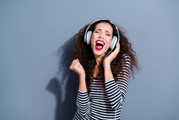Closeup photo portrait of crazy excited funny funky with teeth delightful rejoicing pretty hipster millenial enjoying best sound isolated grey background - 写真・画像