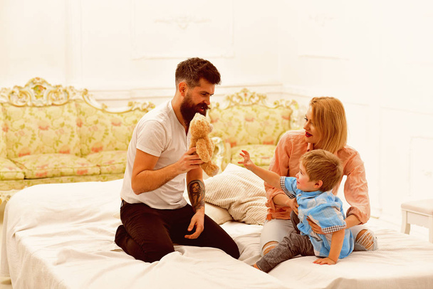 Little boy with dad and mom. happy family and childrens day. little boy play with parents at home. father and mother with child play toys. happy childhood. Care and development. Happy together - Фото, зображення