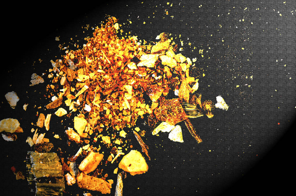 various spices scattered on a dark surface - Photo, Image