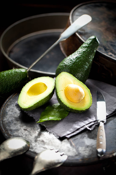 Green avocados on a dark wood background. - Photo, Image