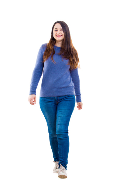 Casual young woman student full length portrait walking confident looking to camera isolated over white background. - Photo, Image