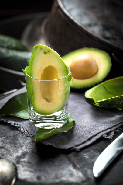 Green avocados on a dark wood background. - Foto, immagini