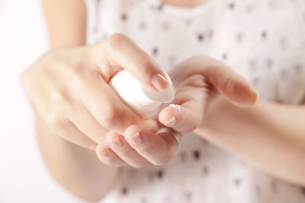 Closeup of female hands applying cream - Foto, imagen