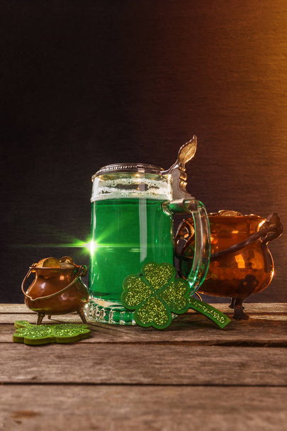 Pot of gold, beer and shamrocks on wooden board - Photo, Image