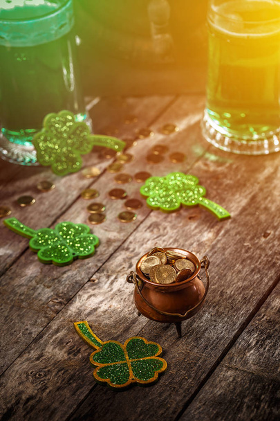 Pot of gold filled with gold coins on vintage wooden background. Saint Patrick's Day theme - Foto, Imagem