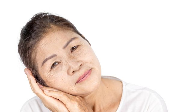 elderly asian woman with wrinkle and freckle on face include white clothes and black hair 60-70 years old in studio head shot of beauty or serenity concept - Photo, Image