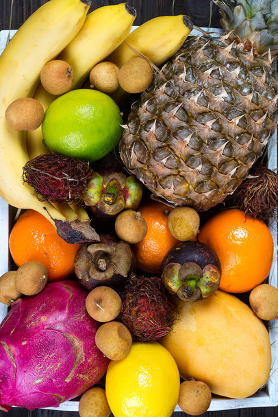 Tropical fruits background, many colorful ripe tropical fruits - Photo, Image