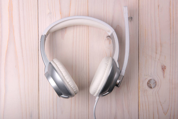 White stylish headphones on a light background - Photo, Image