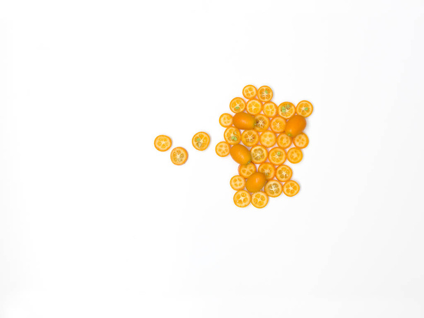 beautifully arranged fresh kumquat slices isolated on white background, close-up  - Fotó, kép