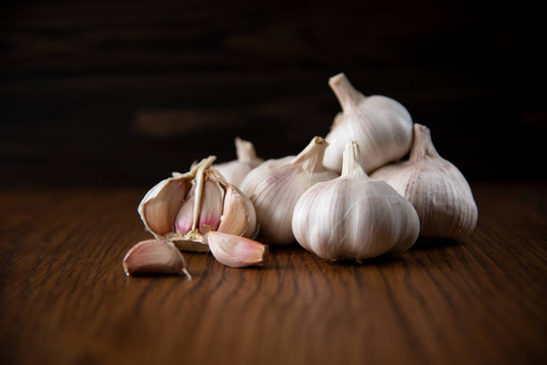 Garlic bulb on the wooden vintage background - Valokuva, kuva