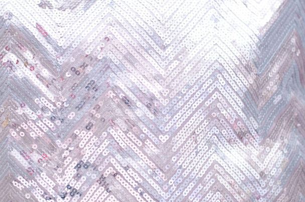 Текстура ткани с мерцающими серебряными блестками. Фон с блестками
. - Фото, изображение