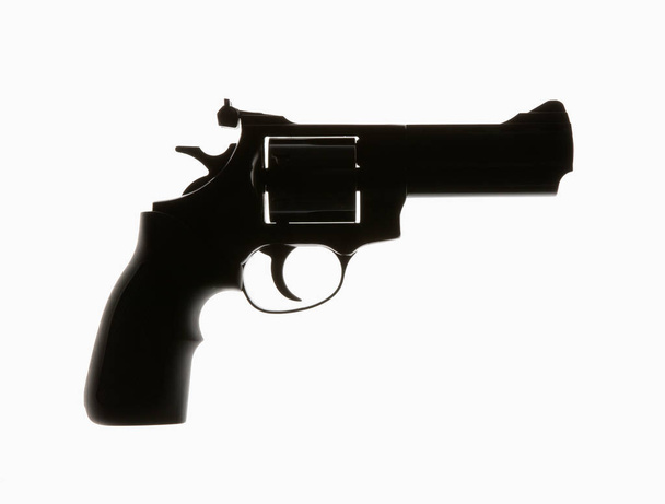 Revolver v silueta na bílém pozadí - Fotografie, Obrázek