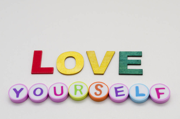 Love yourself phrase made from colorful circles and letters against white background - Photo, Image