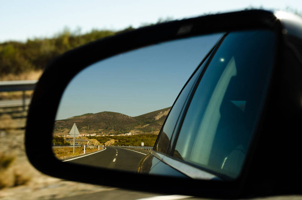 view in the car mirror on fast road in the Spain, beautiful landscape, transportation - Photo, Image
