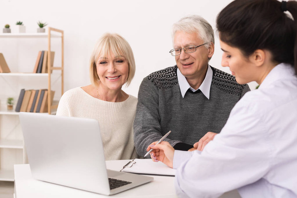 Elderly couple discussing treatment plan with doctor - Photo, Image