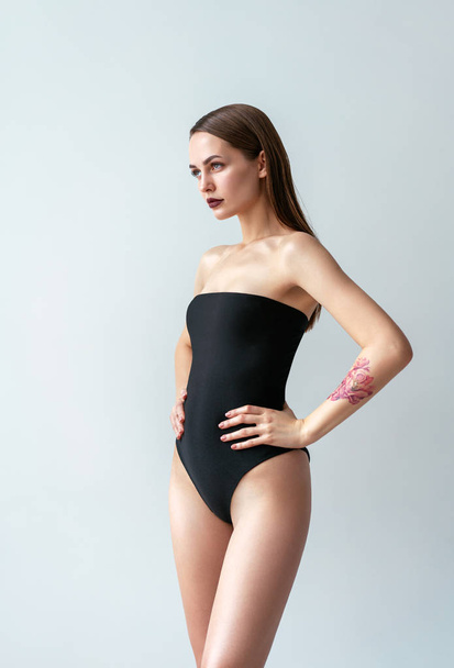 Fashion photo of sexy beautiful woman posing in black swimsuit - Фото, зображення