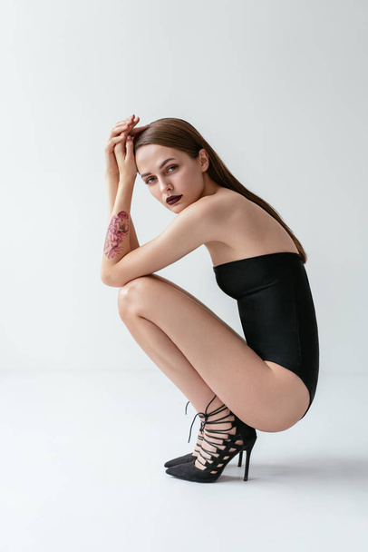 Fashion photo of sexy beautiful woman posing in black swimsuit - Fotografie, Obrázek