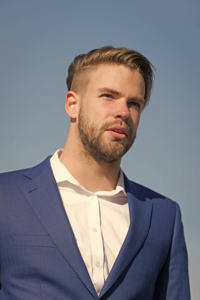 Businessman attractive appearance looks successful. Freedom concept. Businessman successful entrepreneur in suit outdoor sunny day, sky background. Man confident well groomed enjoy freedom, close up - Fotografie, Obrázek
